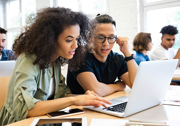 Two students looking at laptop
