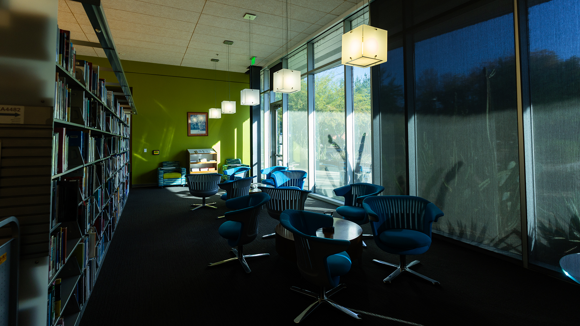 Inside Library, dark space with turquoise chairs