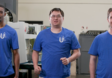 Three males students in blue shirts