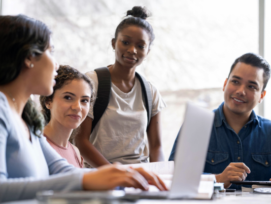 Group of diverse students sitting at table