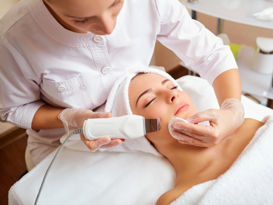 Women receiving a facial treatment in a spa setting.