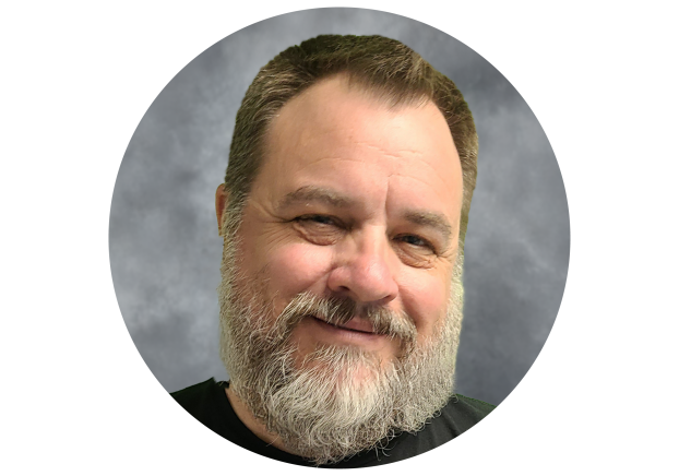 Male wearing black shirt with white and grey beard