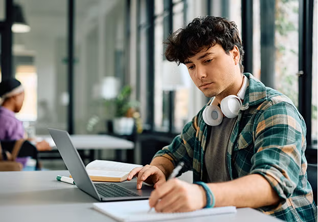 Male student sitting at a desk studying